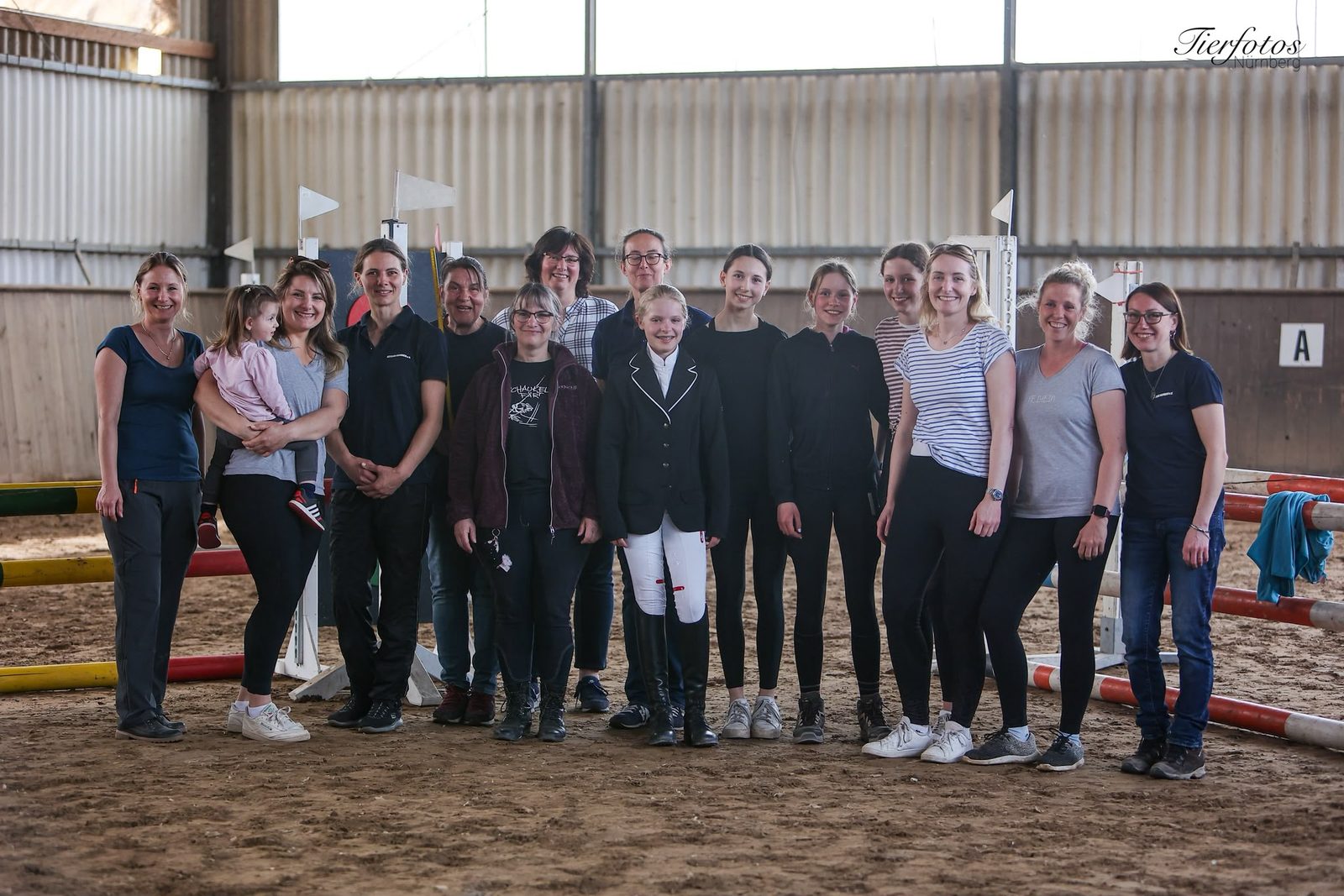 Fröhliche Gruppe von Mitgliedern nach einem Training in der Reithalle